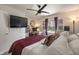 Inviting bedroom with a ceiling fan, a built-in workstation, and a view to the exterior at 4742 Kingsley Dr, Indianapolis, IN 46205