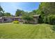 Attractive exterior of the home with a lush green lawn, mature trees, and inviting curb appeal at 4742 Kingsley Dr, Indianapolis, IN 46205