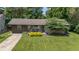 Charming home with a well-maintained lawn, a welcoming front porch, and attractive landscaping at 4742 Kingsley Dr, Indianapolis, IN 46205