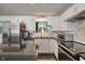Bright kitchen with white cabinets, stainless steel appliances, and stylish lighting fixtures at 4742 Kingsley Dr, Indianapolis, IN 46205