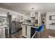 Modern kitchen featuring stainless steel appliances, white cabinets, and a marble island with seating at 4742 Kingsley Dr, Indianapolis, IN 46205