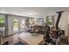 Comfortable living room featuring hardwood floors, a sectional sofa, stylish décor, and backyard access at 4742 Kingsley Dr, Indianapolis, IN 46205