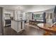 Spacious open-concept living area featuring a kitchen island, dining area, and hardwood floors at 4742 Kingsley Dr, Indianapolis, IN 46205