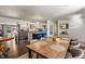 Large open-concept space with dining table and kitchen featuring stainless steel appliances at 4742 Kingsley Dr, Indianapolis, IN 46205