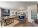 Open-concept living space with a fireplace, dining area, and kitchen island with seating at 4742 Kingsley Dr, Indianapolis, IN 46205