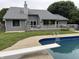 A large in-ground pool with a diving board is adjacent to the home's back deck and outdoor space at 4760 Winterberry Pl, Columbus, IN 47201