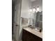 Bathroom features a vanity with modern fixtures, a neutral countertop, and a decorative wall mirror at 4760 Winterberry Pl, Columbus, IN 47201