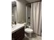 Bathroom with a vanity with modern fixtures and a shower with a tub behind a curtain at 4760 Winterberry Pl, Columbus, IN 47201