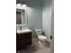 Bathroom features a vanity with modern fixtures, a toilet and a decorative wall mirror at 4760 Winterberry Pl, Columbus, IN 47201