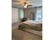Bedroom with neutral carpeting, a closet, a caged dog, and a bed that is not made at 4760 Winterberry Pl, Columbus, IN 47201