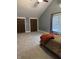 Bedroom with neutral carpeting, a peaked ceiling, a bed and two closets with brown doors at 4760 Winterberry Pl, Columbus, IN 47201