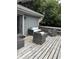Cozy deck featuring weathered wood, gray outdoor furniture, and access to the home at 4760 Winterberry Pl, Columbus, IN 47201
