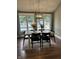 Elegant dining room featuring a decorative chandelier and a view of the backyard pool at 4760 Winterberry Pl, Columbus, IN 47201
