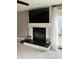 Bright living room with a modern fireplace, a ceiling fan, and door to the backyard deck at 4760 Winterberry Pl, Columbus, IN 47201