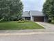 Charming home featuring a well-manicured lawn and an attached two-car garage at 4760 Winterberry Pl, Columbus, IN 47201