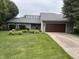Charming home featuring a well-manicured lawn and an attached two-car garage at 4760 Winterberry Pl, Columbus, IN 47201