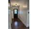 Inviting entryway boasting wainscoting, modern lighting, and stunning hardwood floors at 4760 Winterberry Pl, Columbus, IN 47201