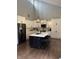 Bright kitchen features stainless steel appliances, a kitchen island, and hardwood flooring at 4760 Winterberry Pl, Columbus, IN 47201