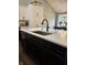 Close-up of kitchen island featuring a stainless steel sink, countertop, and faucet at 4760 Winterberry Pl, Columbus, IN 47201