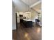 Open floor plan concept of the kitchen area with white cabinets, an island, hardwood floors, and access to the dining room at 4760 Winterberry Pl, Columbus, IN 47201