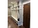 Spacious mudroom with custom built-ins, seating, storage, and hardwood flooring at 4760 Winterberry Pl, Columbus, IN 47201