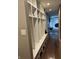 Hallway featuring a spacious mudroom area with custom built-ins and hardwood flooring at 4760 Winterberry Pl, Columbus, IN 47201