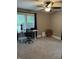 Home office with a modern desk, rolling office chair, neutral carpet, and a ceiling fan at 4760 Winterberry Pl, Columbus, IN 47201