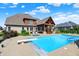 Backyard oasis with pool, diving board, pool house, lounge area, and large lawn offers the perfect space for entertaining at 4931 Kerrington Blvd, Bargersville, IN 46106
