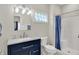 Bright bathroom featuring a vanity with a granite countertop, framed mirror, and a shower with blue curtains at 4931 Kerrington Blvd, Bargersville, IN 46106
