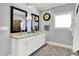 Dual mirrors reflect granite countertops in a pristine, gray-walled bathroom at 4931 Kerrington Blvd, Bargersville, IN 46106