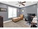 Bedroom with neutral walls, light carpet, ceiling fan, window with blinds, and a sitting and workspace at 4931 Kerrington Blvd, Bargersville, IN 46106