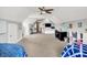 Spacious bedroom featuring two beds, a ceiling fan, and an expansive carpeted floor at 4931 Kerrington Blvd, Bargersville, IN 46106