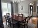 Dining area has a large window, chandelier, and hardwood floors perfect for formal occasions at 4931 Kerrington Blvd, Bargersville, IN 46106