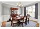 Bright dining room featuring a wood table with six chairs, china cabinet and modern lighting at 4931 Kerrington Blvd, Bargersville, IN 46106