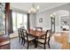 Formal dining room featuring a wood table, six chairs, chandelier, and large bright windows at 4931 Kerrington Blvd, Bargersville, IN 46106