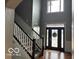 Grand two-story foyer features a staircase and ornate glass front door, welcoming you into this charming home at 4931 Kerrington Blvd, Bargersville, IN 46106