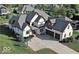 Stunning two-story home boasts a brick facade, three-car garage, and a spacious driveway with a basketball hoop at 4931 Kerrington Blvd, Bargersville, IN 46106