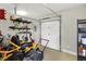 Garage with epoxy flooring featuring a riding lawnmower and shelving at 4931 Kerrington Blvd, Bargersville, IN 46106