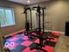Well-equipped home gym featuring a full weight rack and rubber flooring, great for fitness enthusiasts at 4931 Kerrington Blvd, Bargersville, IN 46106