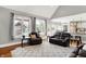 Open living room featuring a kitchen view, hardwood floors, and comfortable leather furniture at 4931 Kerrington Blvd, Bargersville, IN 46106