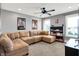 A comfy sectional sofa and ceiling fan offer a relaxing space in this finished room at 4931 Kerrington Blvd, Bargersville, IN 46106