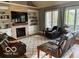 Relax in the living room with a fireplace, built-in shelves, and plush seating for ultimate comfort at 4931 Kerrington Blvd, Bargersville, IN 46106