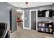A versatile office space features a TV and a doorway leading to an adjacent living area at 4931 Kerrington Blvd, Bargersville, IN 46106