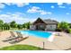 Backyard pool with a pool house featuring an outdoor living space, creating a backyard oasis at 4931 Kerrington Blvd, Bargersville, IN 46106
