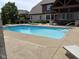 Large backyard pool with ample patio space, ideal for outdoor recreation and entertainment at 4931 Kerrington Blvd, Bargersville, IN 46106