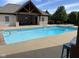 Refreshing outdoor pool with a diving board and sun-soaked patio, perfect for summer enjoyment at 4931 Kerrington Blvd, Bargersville, IN 46106