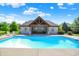 Resort-style pool with a pool house, lush greenery, and comfortable seating, perfect for relaxation at 4931 Kerrington Blvd, Bargersville, IN 46106