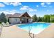 Beautiful in-ground pool with a pool house and lounge chairs on the deck, perfect for outdoor relaxation at 4931 Kerrington Blvd, Bargersville, IN 46106