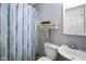 A cozy bathroom featuring a sink, toilet and striped shower curtain at 50 Crestview Dr, Greenwood, IN 46143