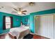 Bedroom featuring blue walls, ceiling fan, double closet, and hardwood floors at 50 Crestview Dr, Greenwood, IN 46143